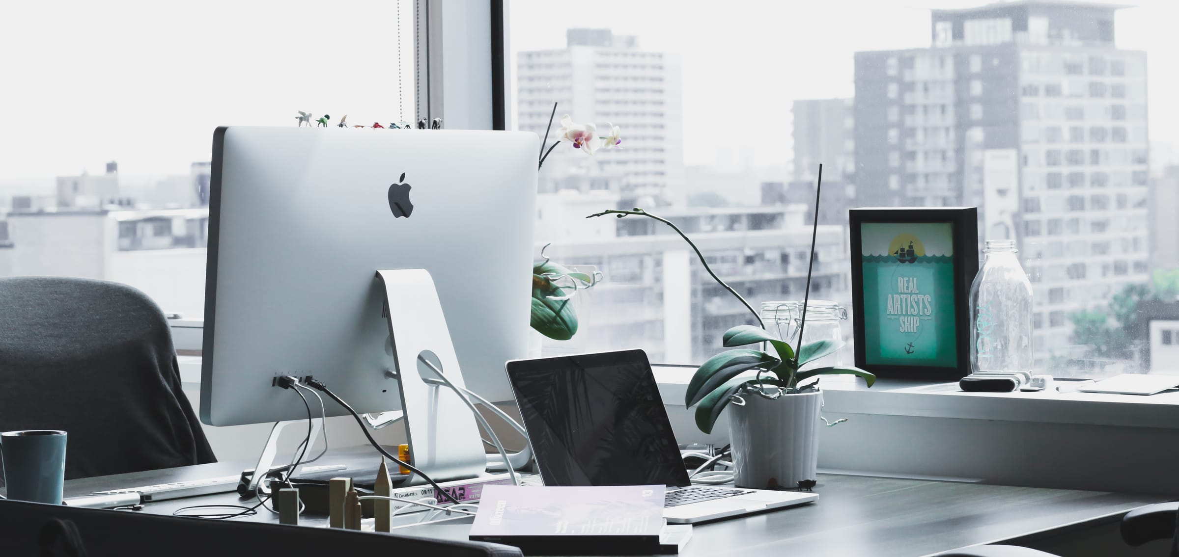 Desk with a computer facing the city